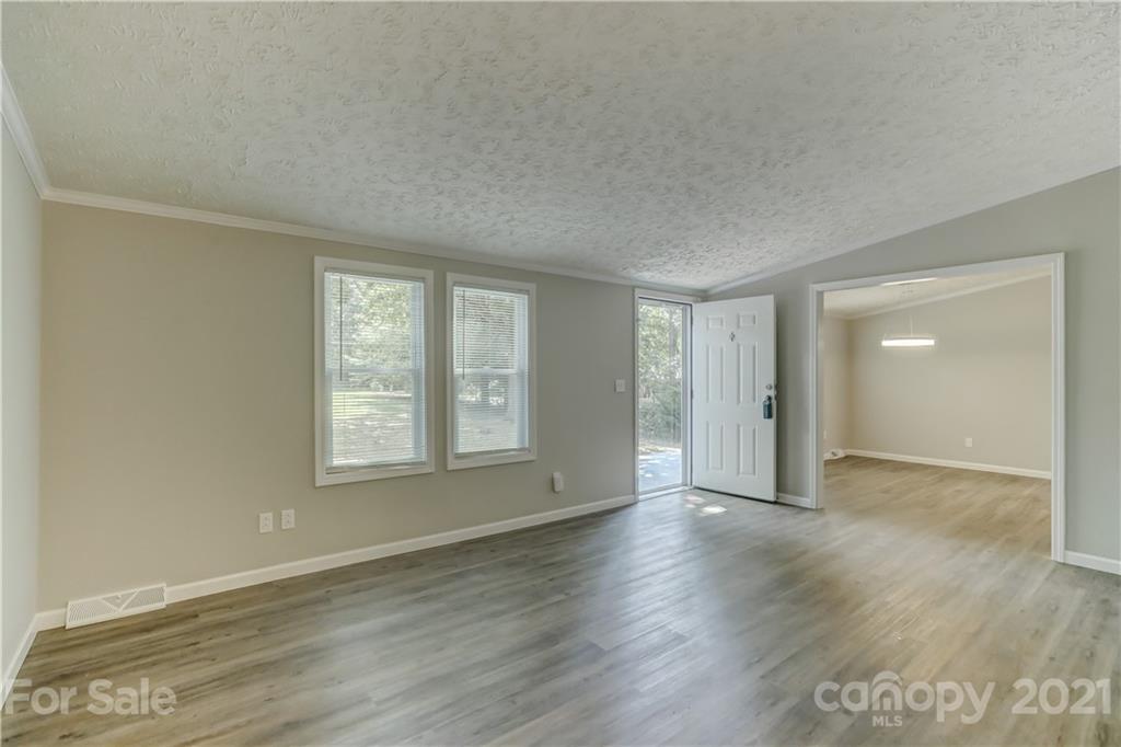 179 Davidson Road Clover, SC 29710 - Photo 6 of 31 an empty room with wooden floor and windows