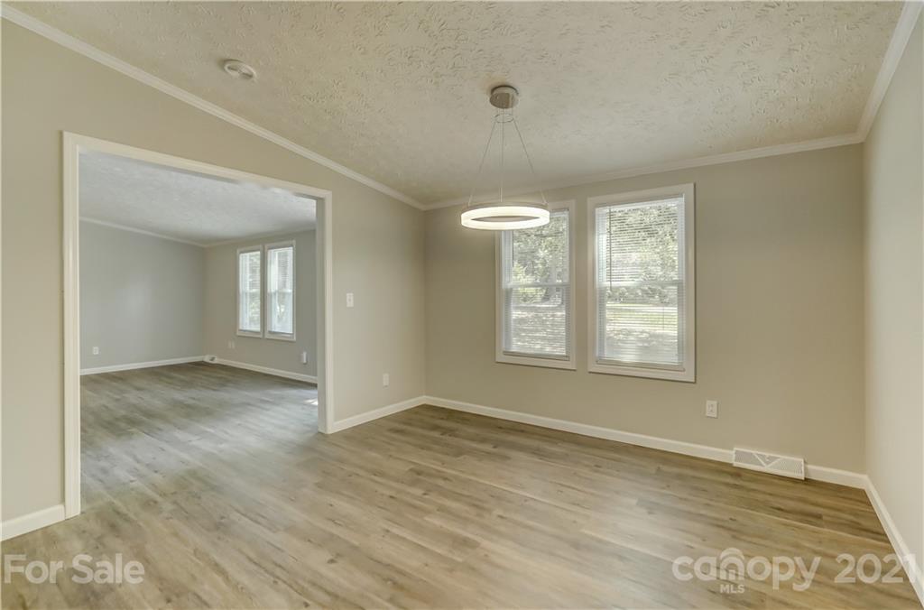 179 Davidson Road Clover, SC 29710 - Photo 8 of 31 an empty room with wooden floor and windows