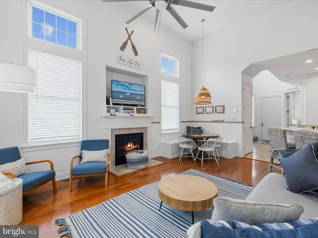 a living room with furniture a fireplace and a window