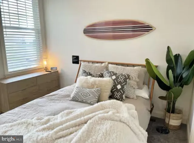 a bedroom with a bed and a potted plant