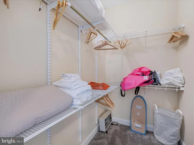 a bedroom with a bed and chandelier
