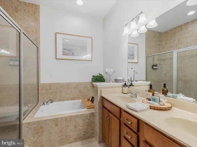 a bathroom with a tub sink and mirror