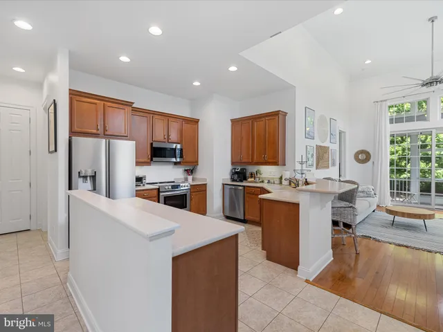 a large kitchen with stainless steel appliances lots of counter top space cabinets and a sink