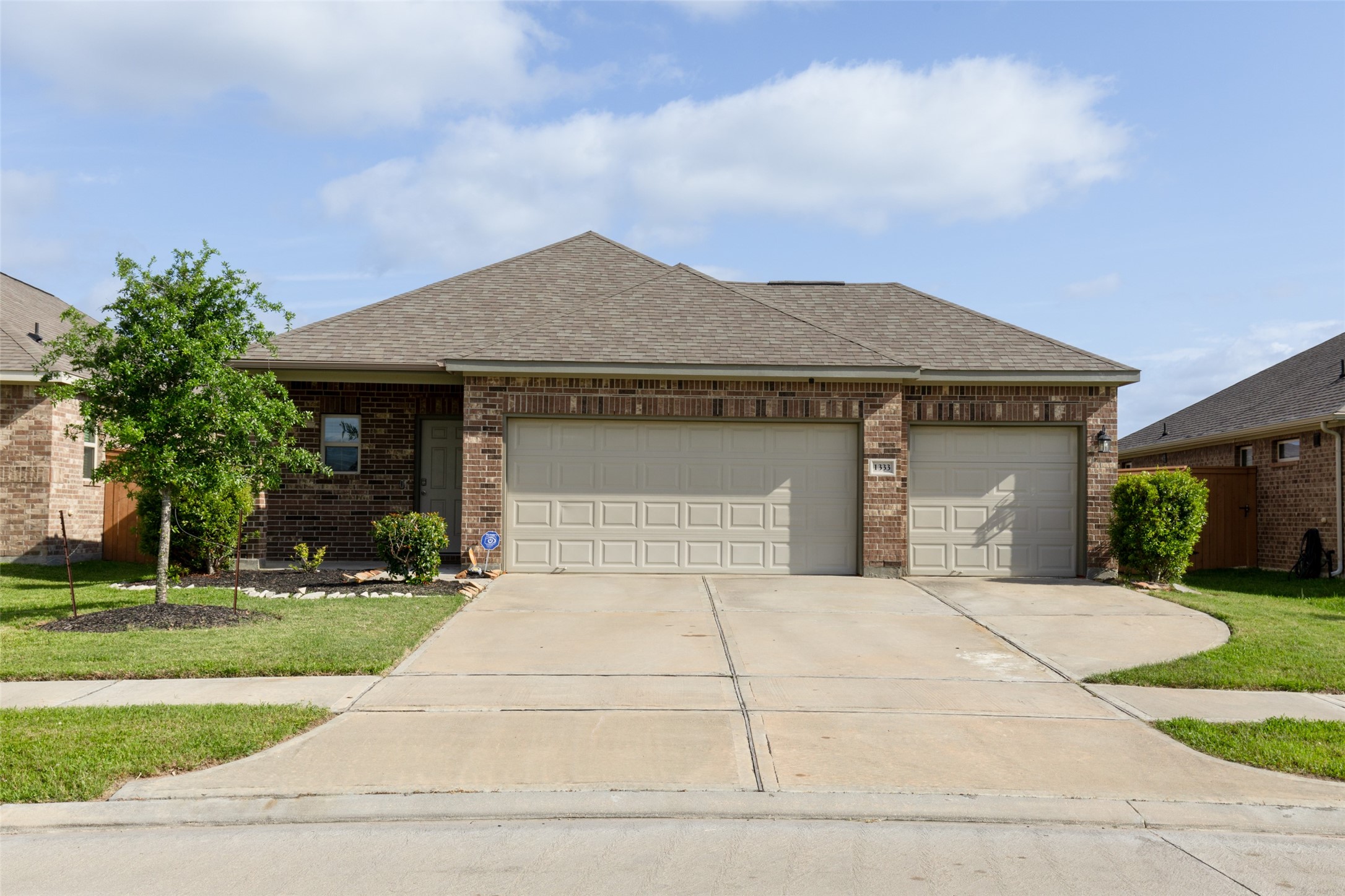 1333 Red Hills Drive Rosharon, TX 77583 - Photo 3 of 29 a front view of a house with a yard and garage