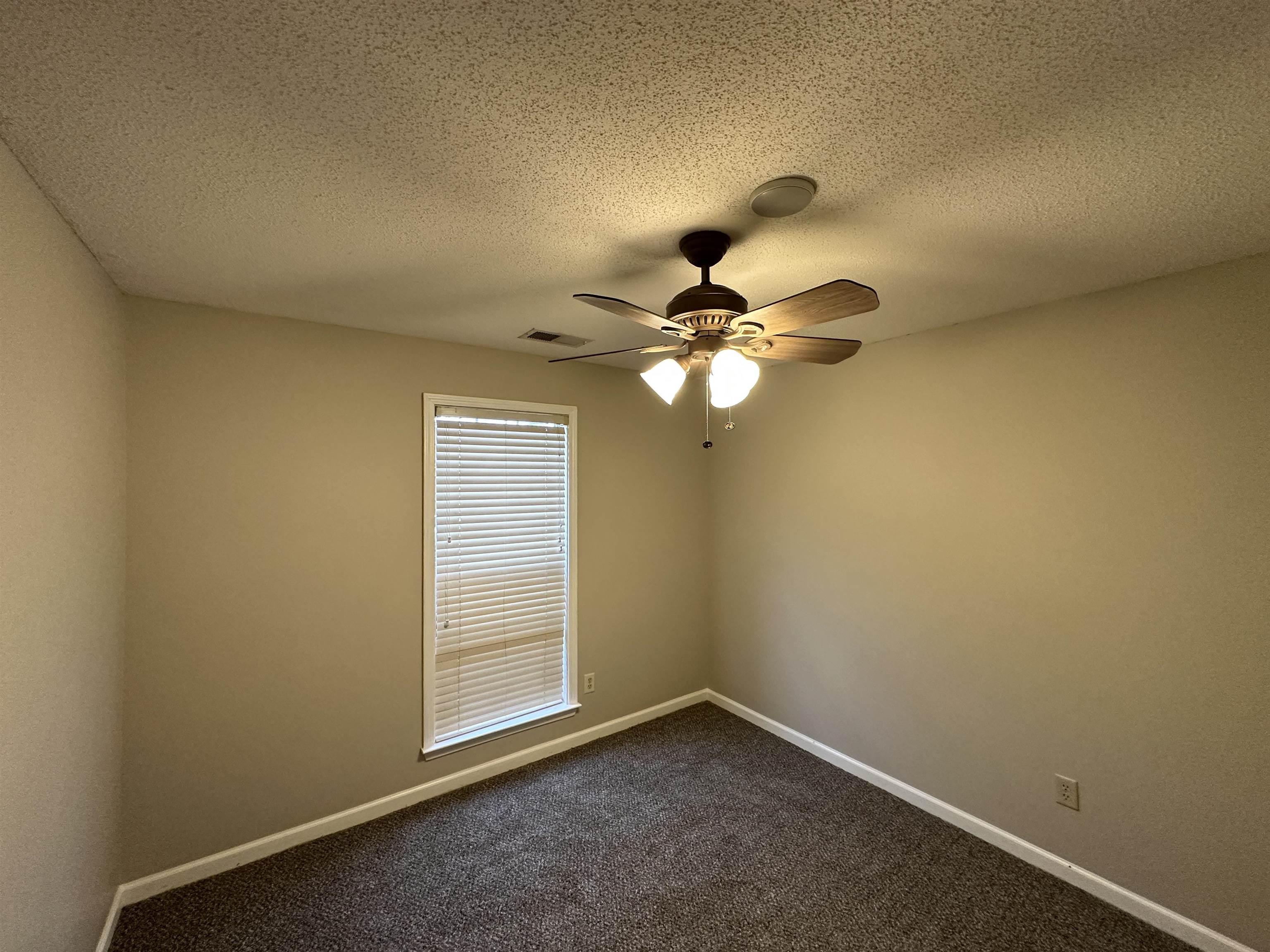 10144 Lynham Drive Cordova, TN 38016 - Photo 12 of 15 an empty room with a window and a fan