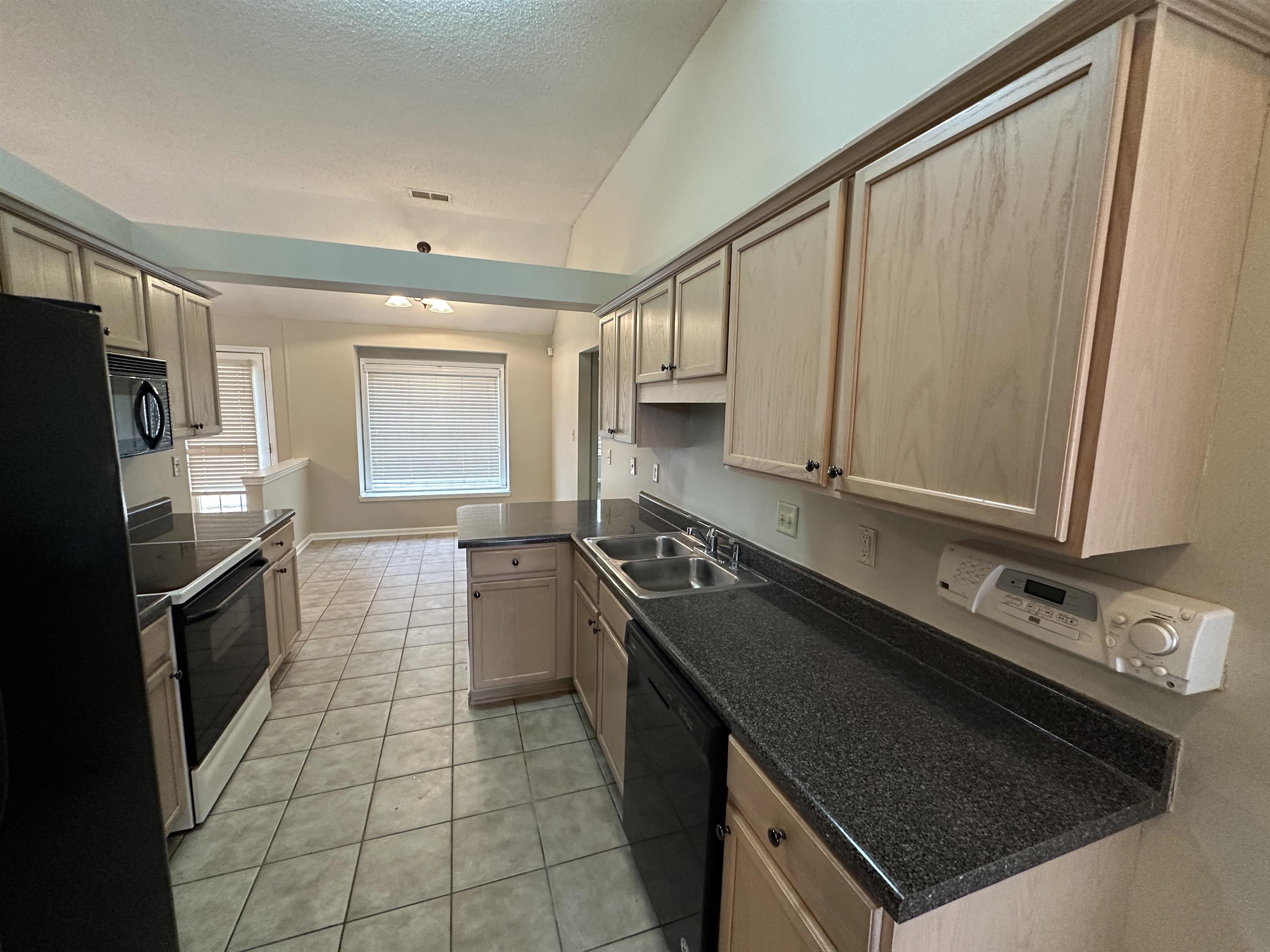 10144 Lynham Drive Cordova, TN 38016 - Photo 4 of 15 a kitchen with a sink a stove top oven and refrigerator