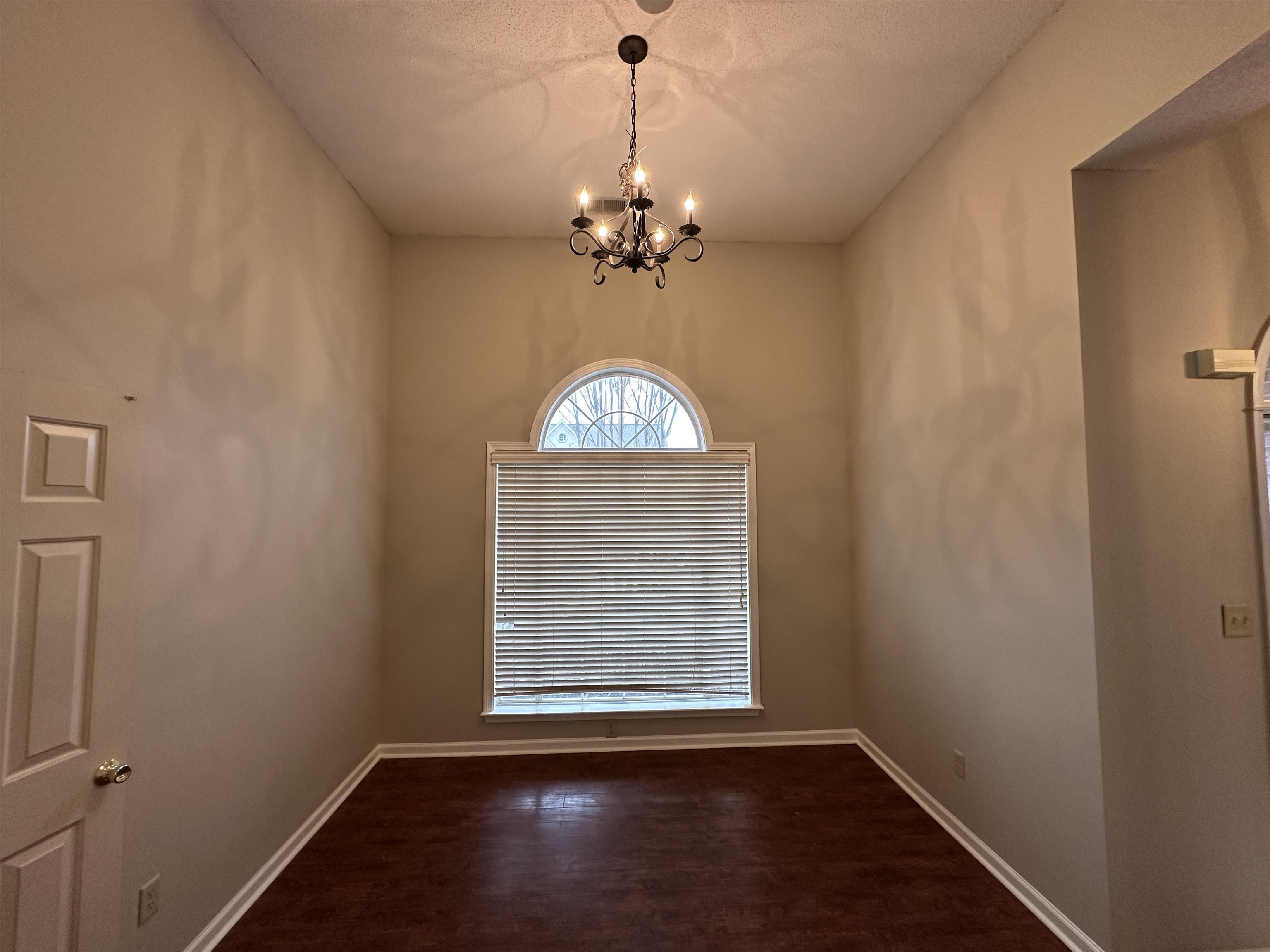 10144 Lynham Drive Cordova, TN 38016 - Photo 6 of 15 a view of an empty room with window and wooden floor