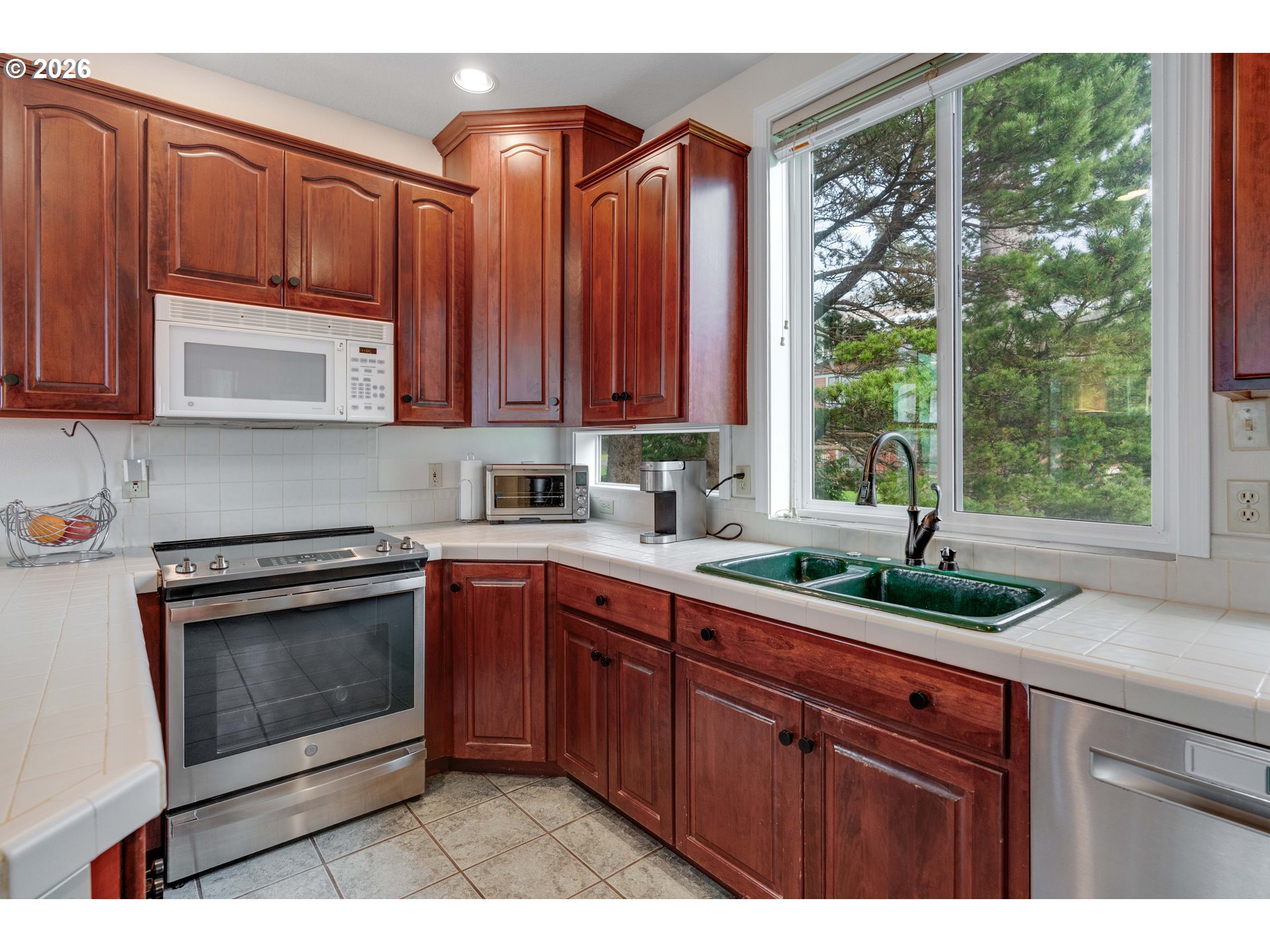 1435 Sunset Avenue Oceanside, OR 97141 - Photo 12 of 46 a kitchen with granite countertop a sink stainless steel appliances and cabinets