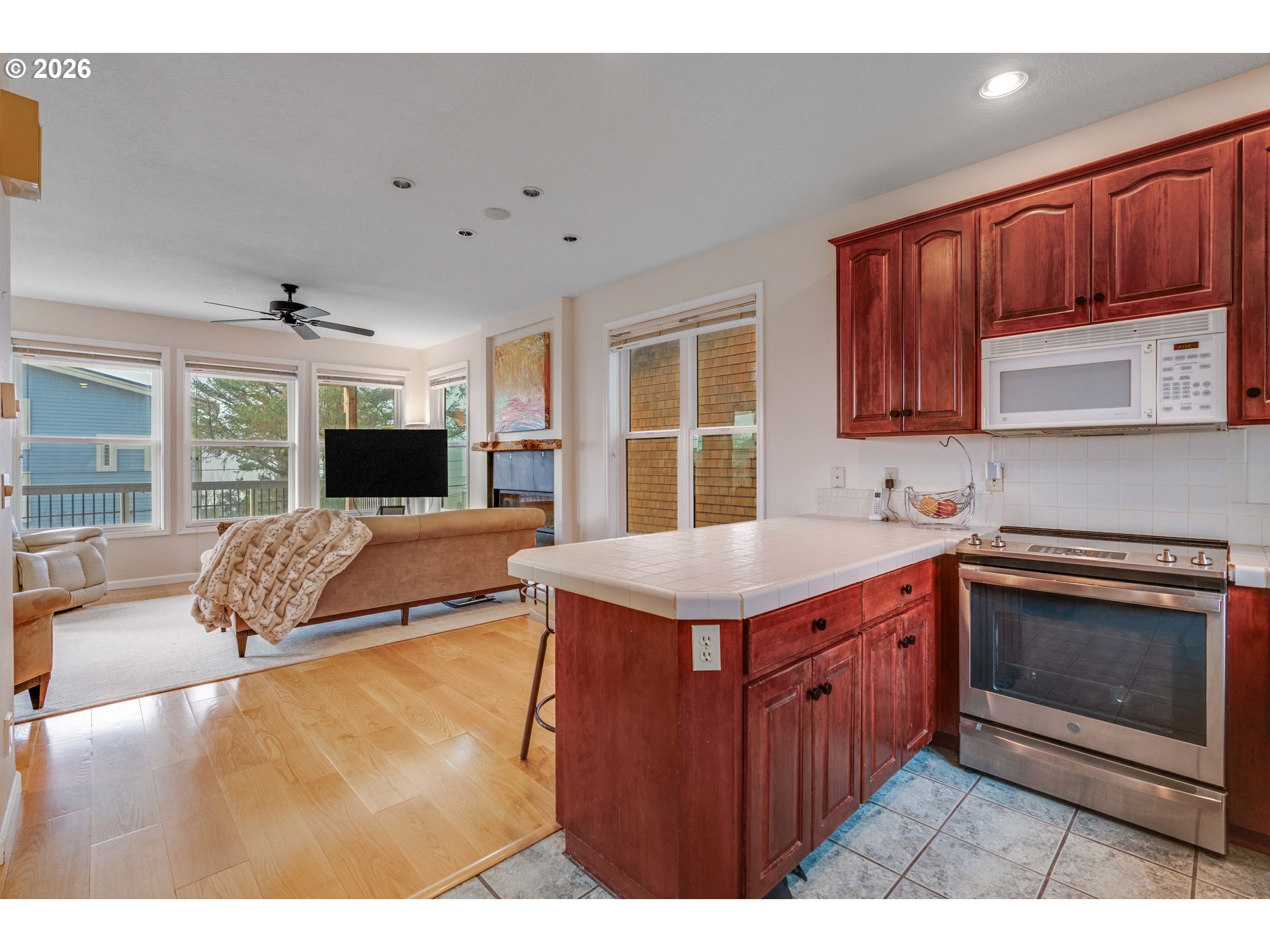 1435 Sunset Avenue Oceanside, OR 97141 - Photo 14 of 46 a kitchen with kitchen island granite countertop a stove top oven cabinets a sink and a counter top space