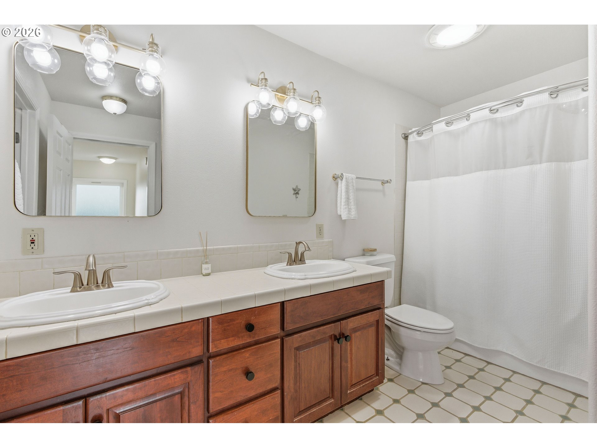 1435 Sunset Avenue Oceanside, OR 97141 - Photo 23 of 46 a bathroom with a double vanity sink toilet and a mirror