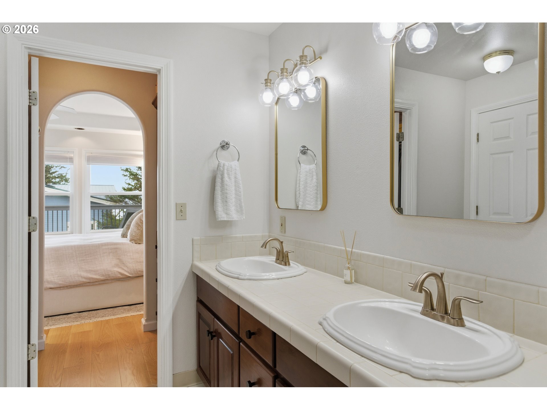 1435 Sunset Avenue Oceanside, OR 97141 - Photo 24 of 46 a bathroom with a double vanity sink and a mirror