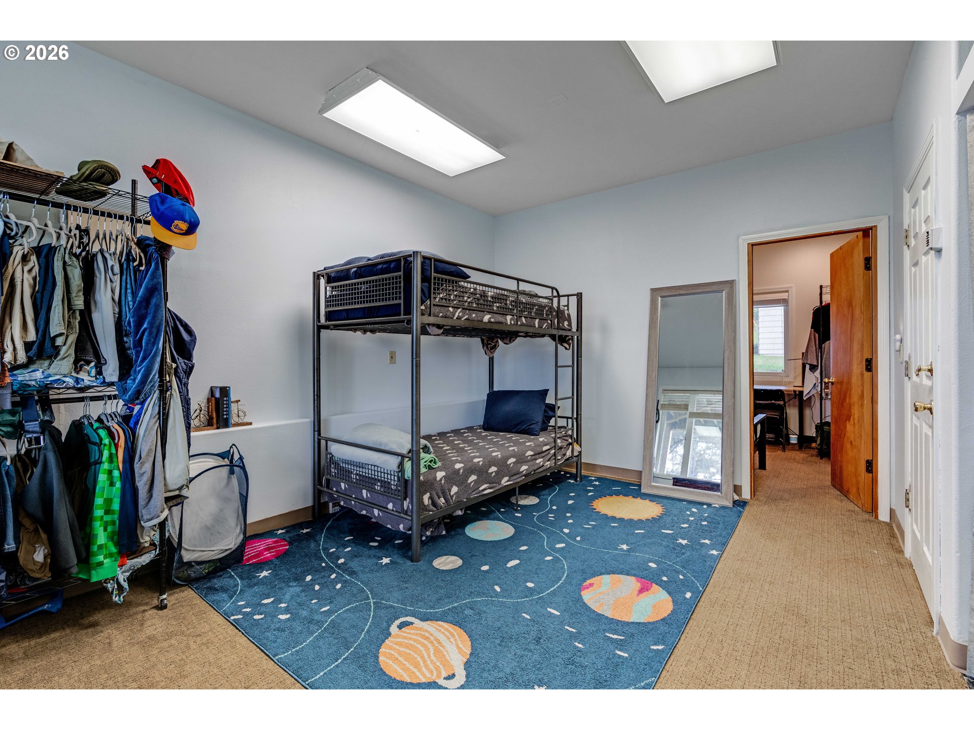 1435 Sunset Avenue Oceanside, OR 97141 - Photo 25 of 46 a bed room with a bed and a book shelf