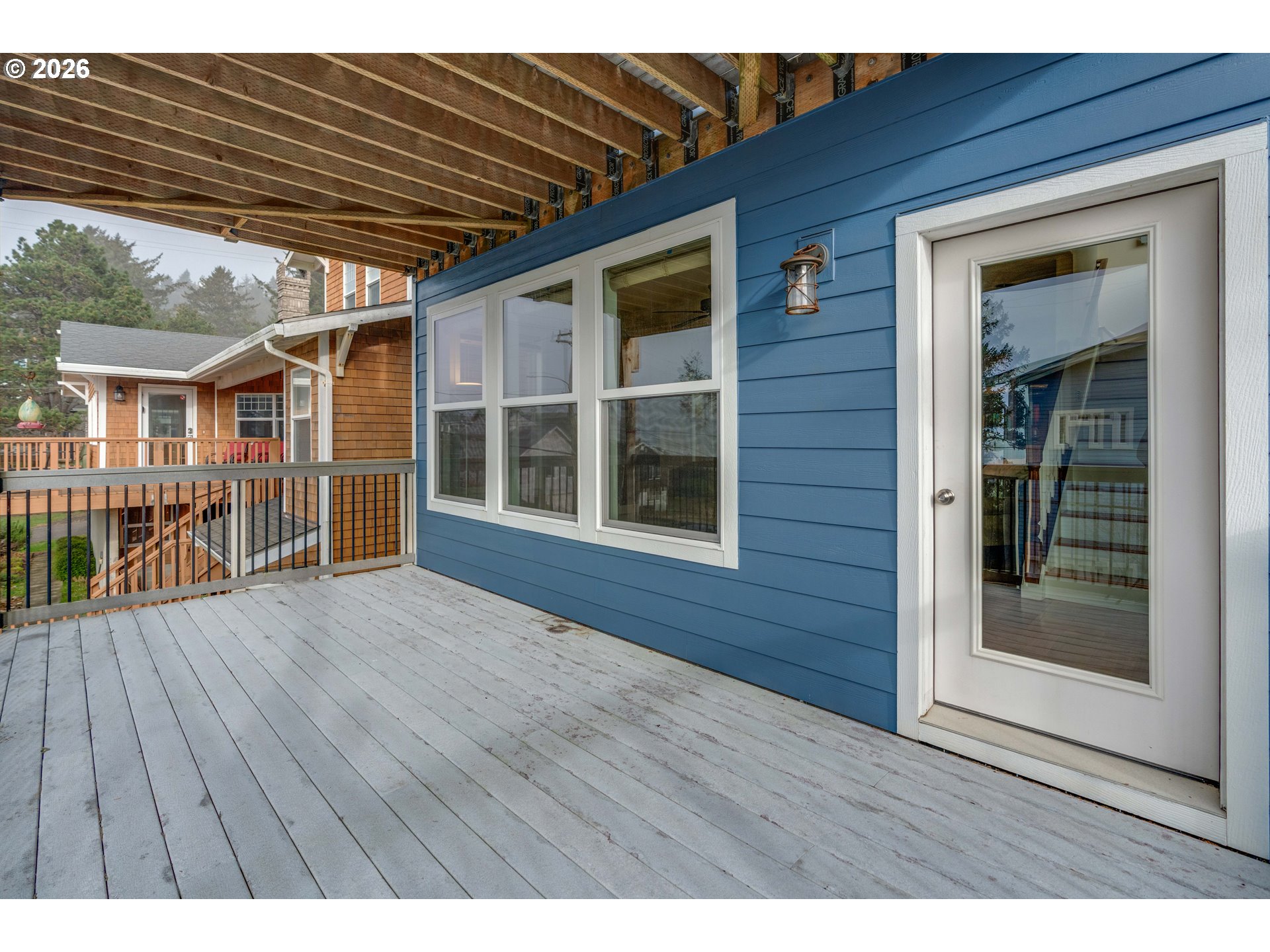 1435 Sunset Avenue Oceanside, OR 97141 - Photo 31 of 46 a view of house with deck outdoor seating and wooden floor