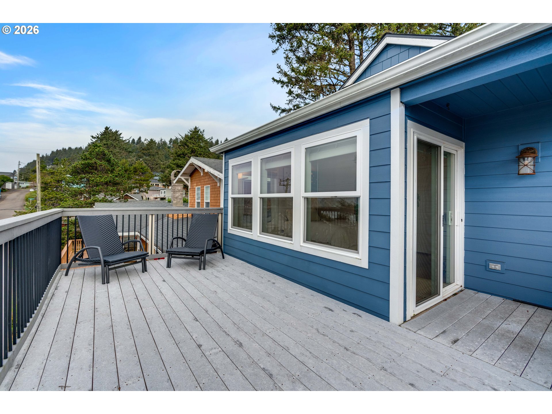 1435 Sunset Avenue Oceanside, OR 97141 - Photo 35 of 46 a balcony with wooden floor table and chairs