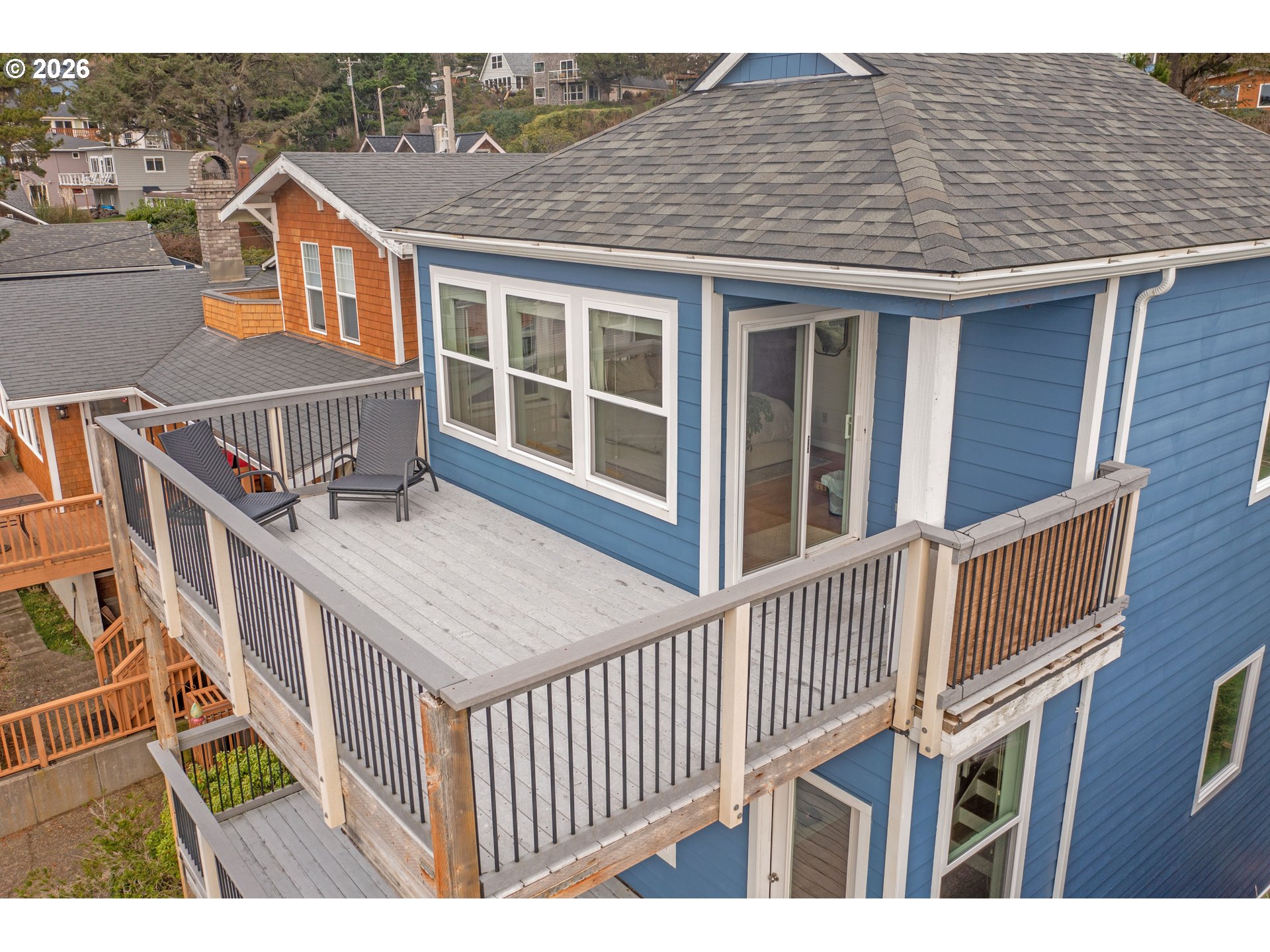 1435 Sunset Avenue Oceanside, OR 97141 - Photo 36 of 46 a view of a brick house with wooden fence