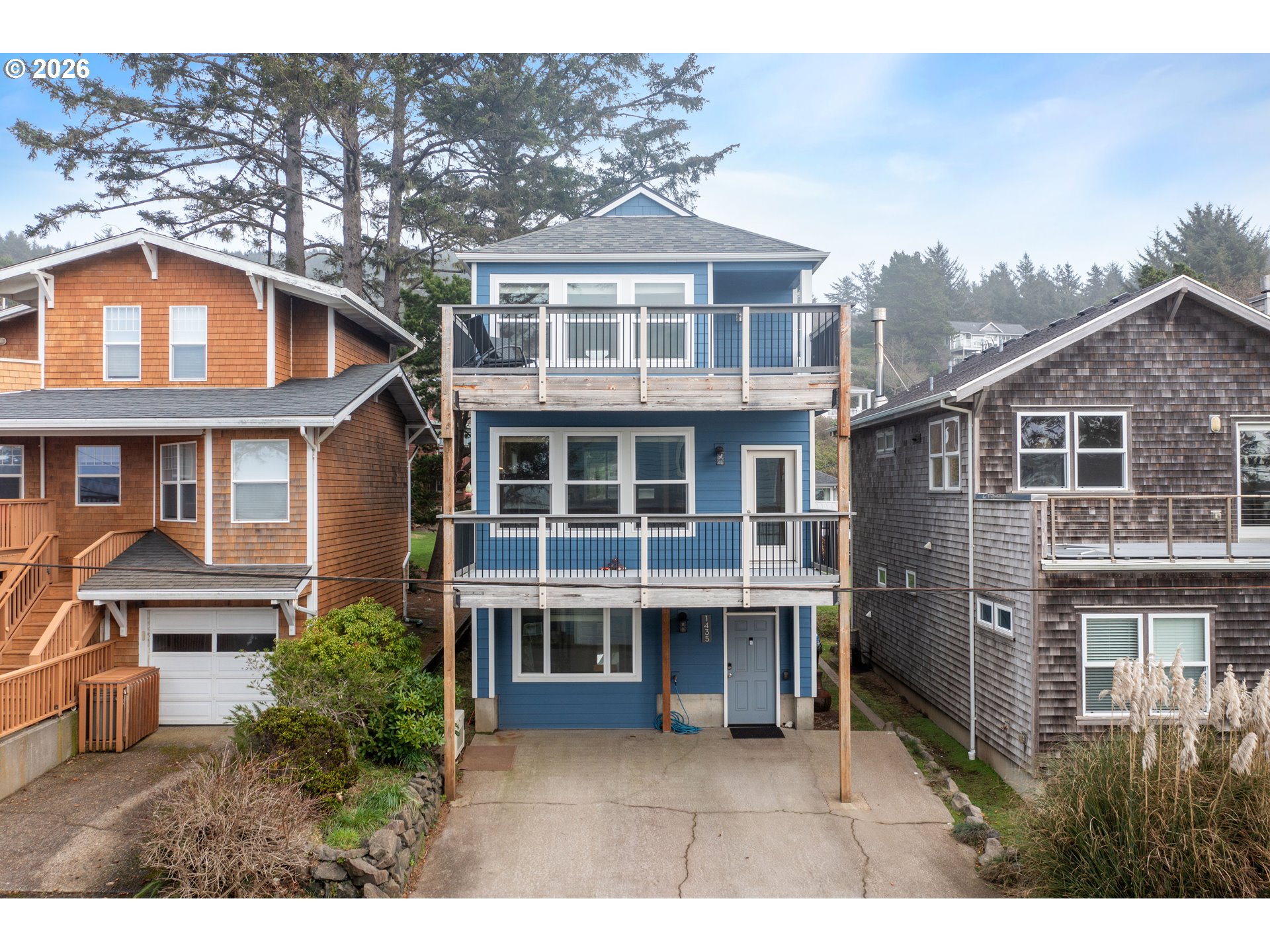 1435 Sunset Avenue Oceanside, OR 97141 - Photo 38 of 46 a view of a brick house with large windows and a table and chairs