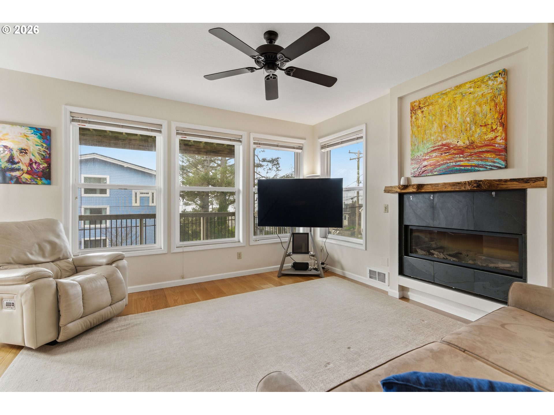 1435 Sunset Avenue Oceanside, OR 97141 - Photo 5 of 46 a living room with furniture a flat screen tv and a fireplace