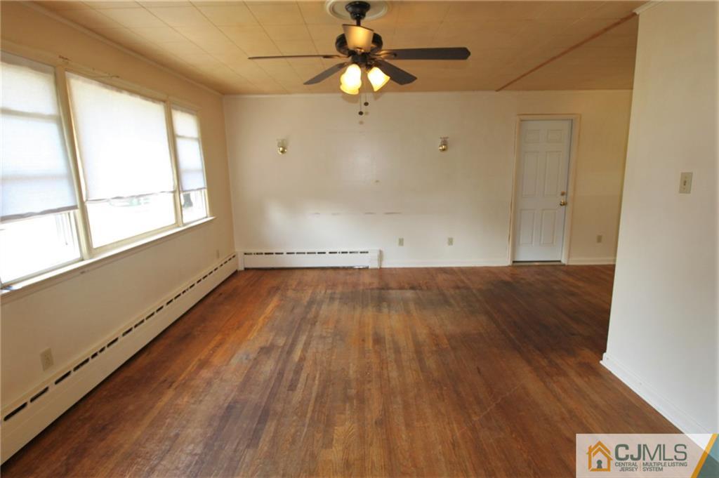 709 Myrtle Road North Brunswick, NJ 08902 - Photo 3 of 16 wooden floor in an empty room with a window