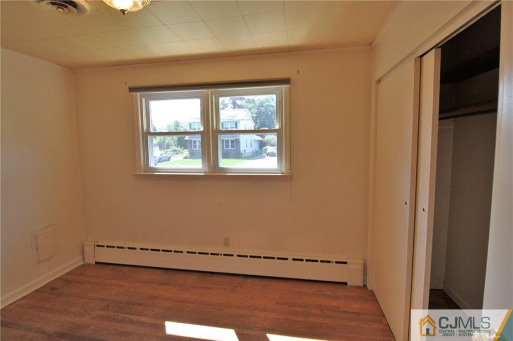 709 Myrtle Road North Brunswick, NJ 08902 - Photo 9 of 16 a view of an empty room with a window and wooden floor