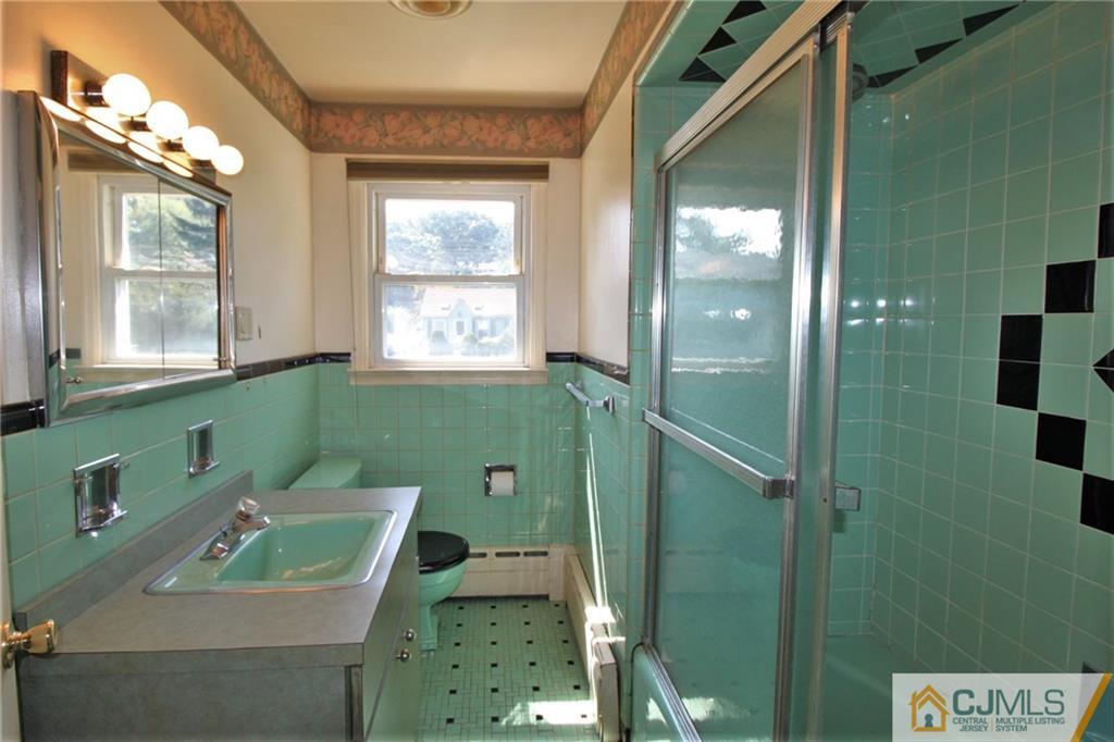 709 Myrtle Road North Brunswick, NJ 08902 - Photo 10 of 16 a bathroom with a sink a toilet and shower