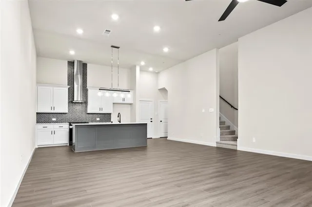 a kitchen with stainless steel appliances granite countertop a sink stove and wooden cabinets