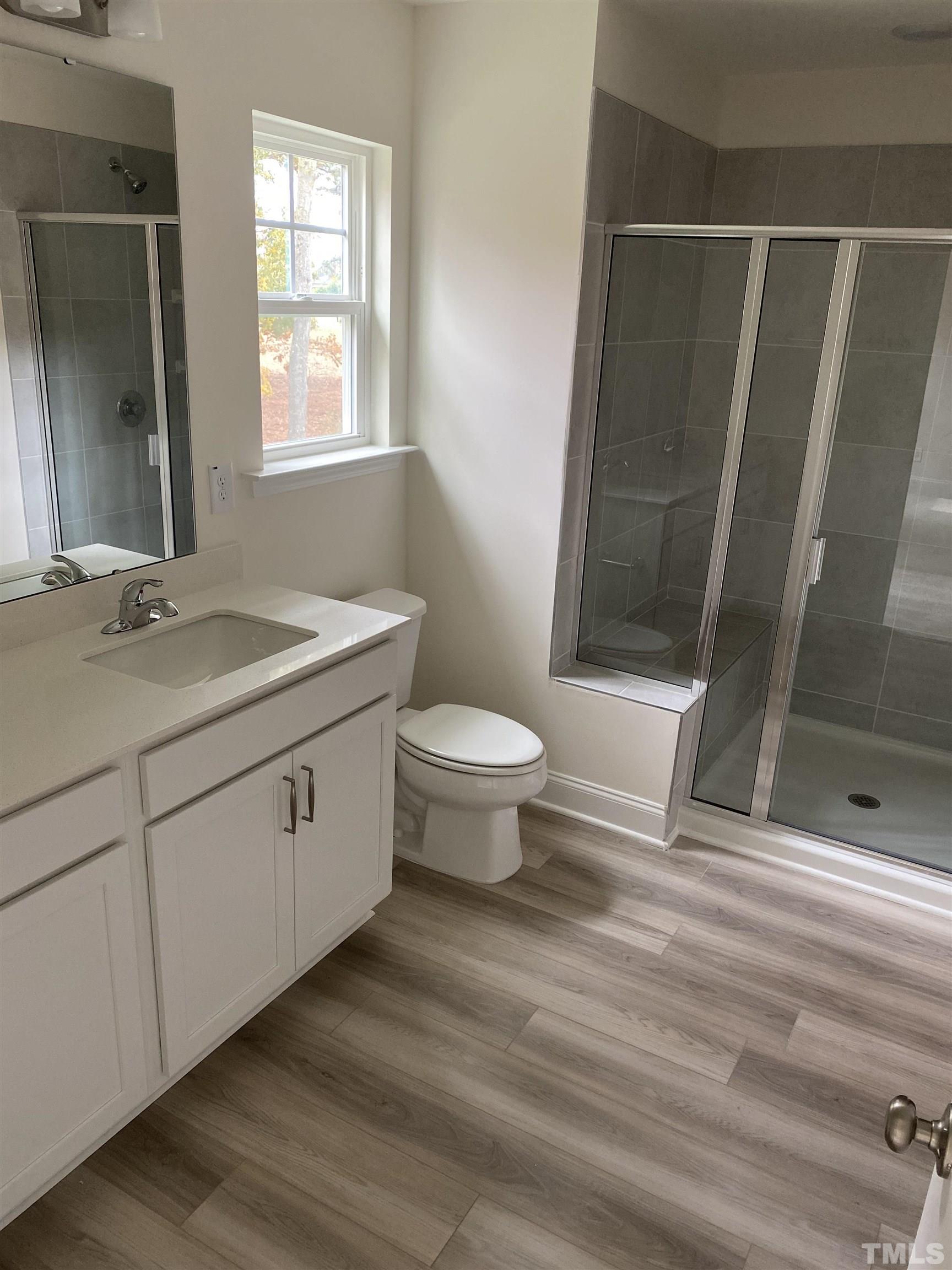 469 Whitley Rdg Drive Clayton, NC 27527 - Photo 6 of 6 a bathroom with a granite countertop sink toilet and shower