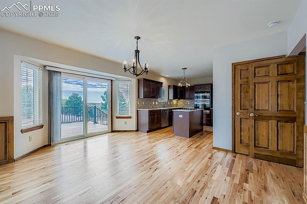 5825 Wilson Road Colorado Springs, CO 80919 - Photo 14 of 48 a view of kitchen with granite countertop stainless steel appliances and wooden floor