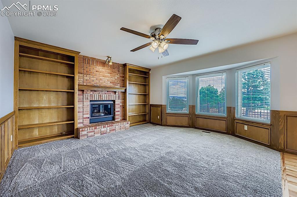 5825 Wilson Road Colorado Springs, CO 80919 - Photo 16 of 48 a view of an empty room with a fireplace and a window