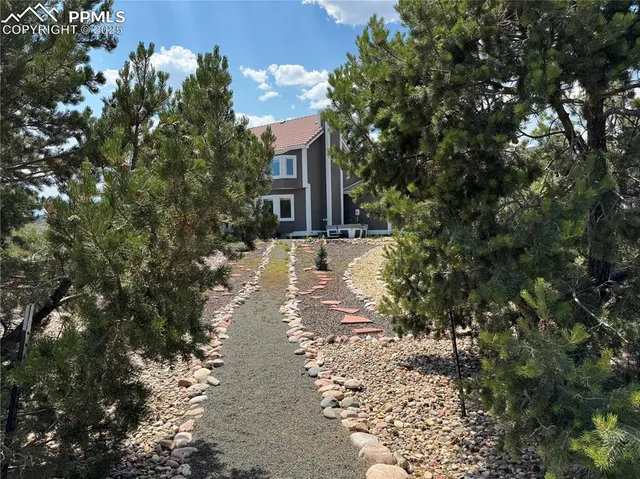 a pathway of a house with a yard