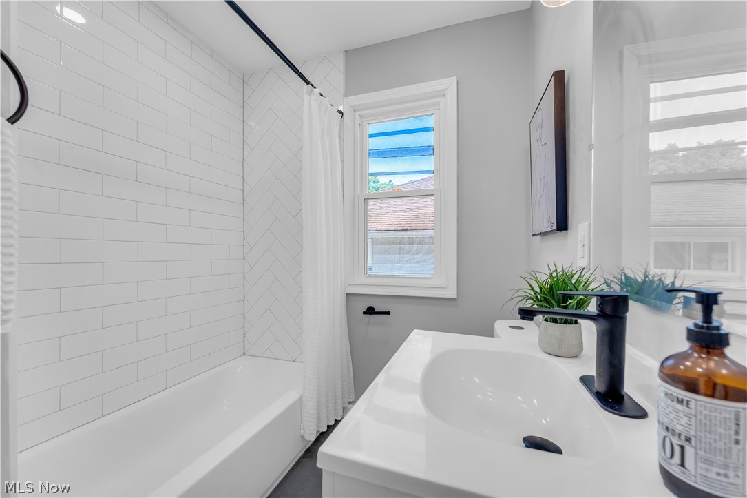 5581 Dunham Road Maple Heights, OH 44137 - Photo 21 of 33 Bathroom featuring shower / bath combo with shower curtain and vanity