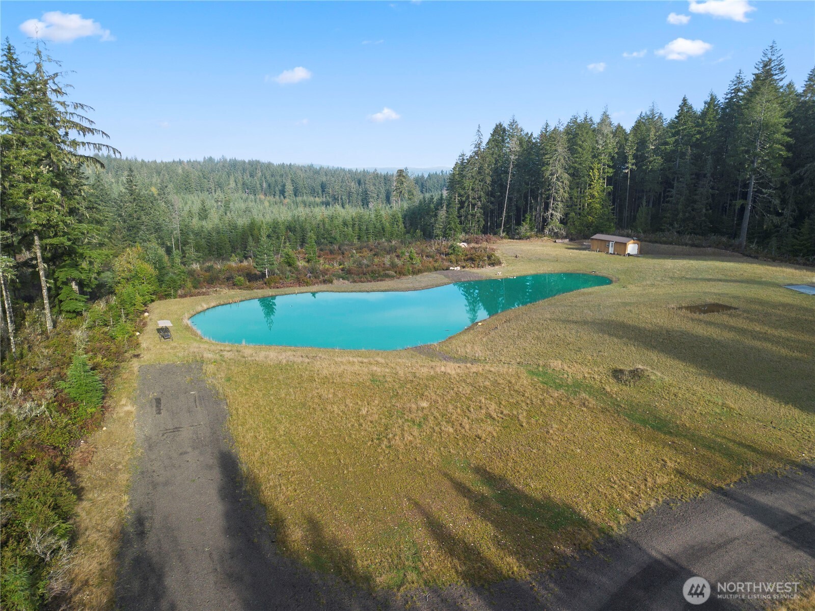 151 East Kingsley Place Belfair, WA 98528 - Photo 5 of 40 a view of a lake with a yard