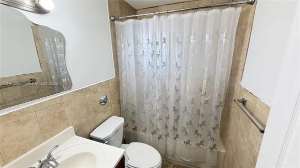 a bathroom with a toilet a sink and a shower