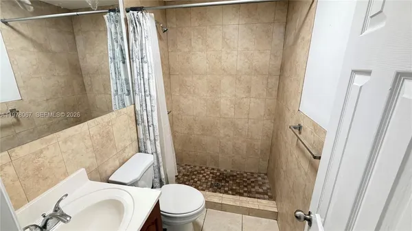 a bathroom with a toilet and shower