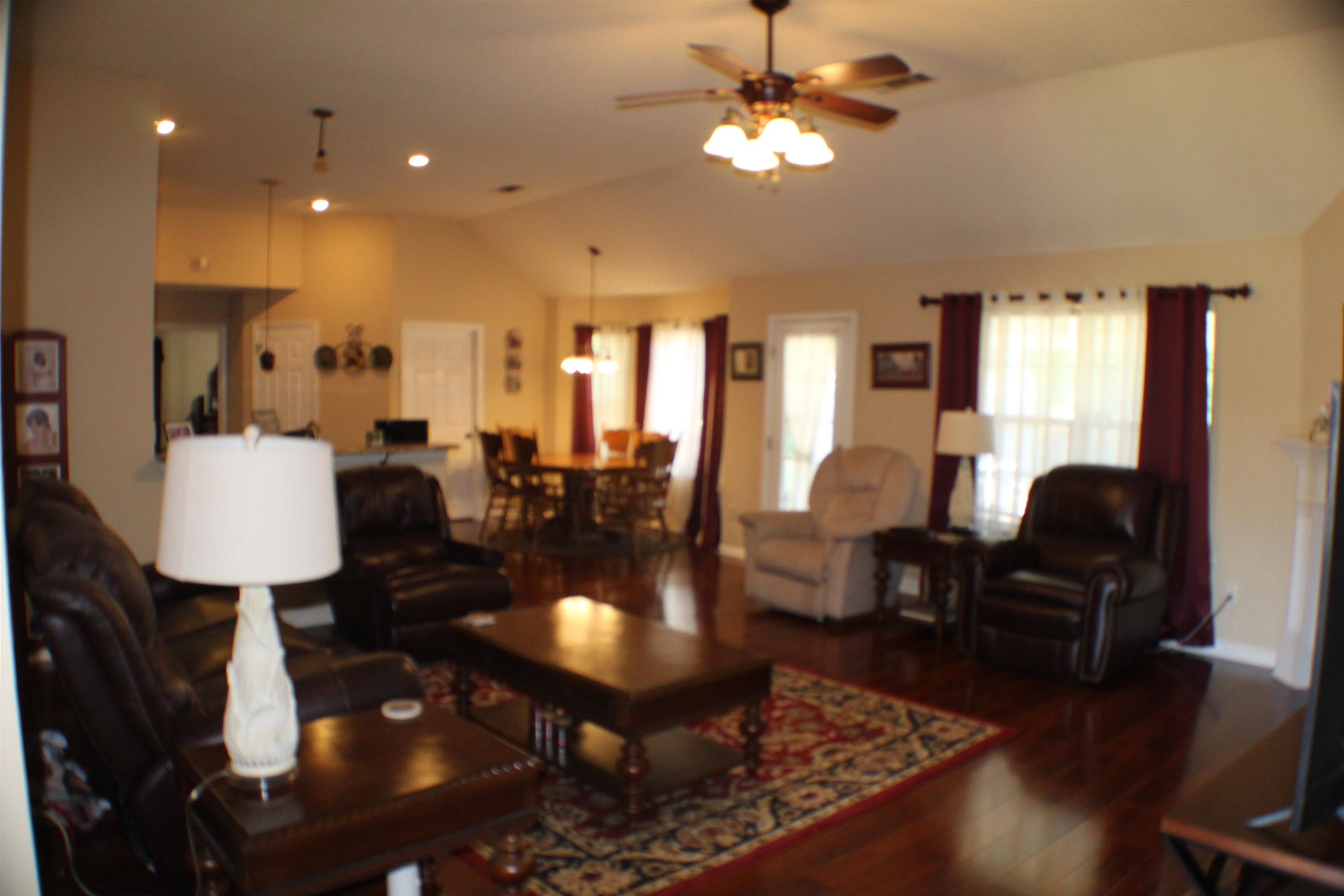 6442 Bending River Road Bartlett, TN 38135 - Photo 7 of 22 Living area with vaulted ceiling, wood finished floors, and a ceiling fan