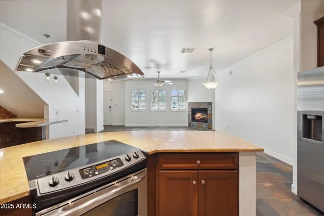 a kitchen with a stove and a wooden floor