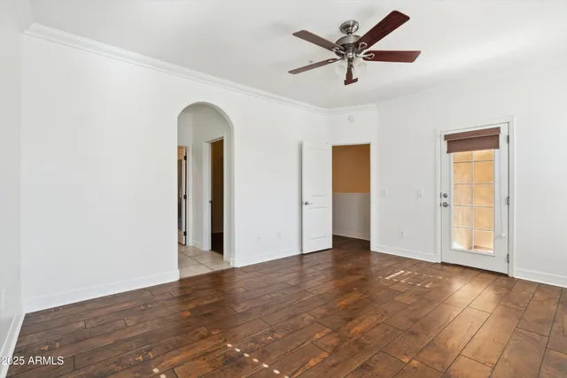 a view of a livingroom with wooden floor and a ceiling fan