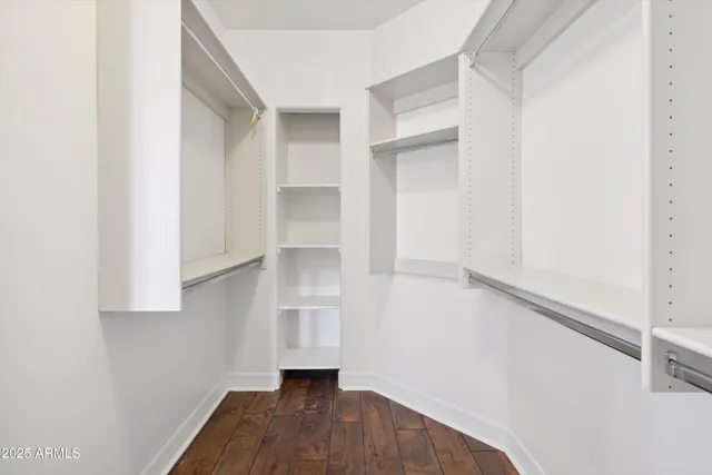a view of walk in closet with empty racks