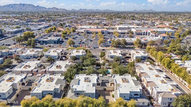 an aerial view of a residential apartment building with parking