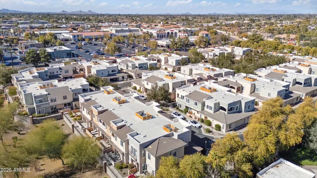 an aerial view of residential houses with outdoor space and trees
