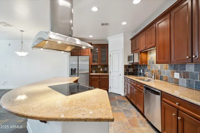 a kitchen with stainless steel appliances granite countertop a sink a stove and a microwave