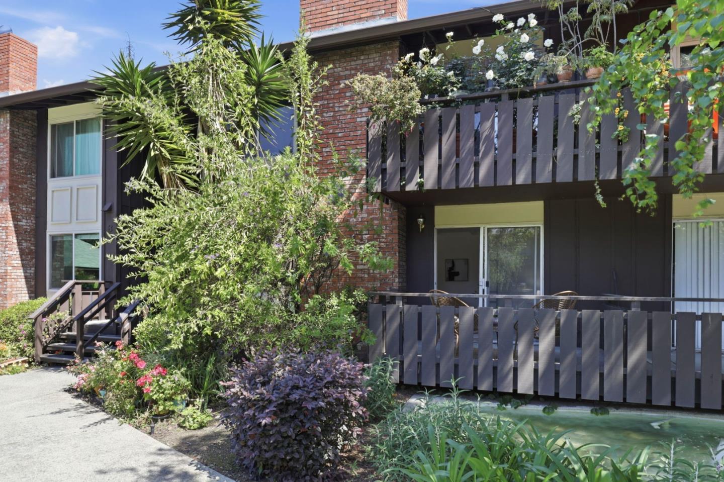 100 East Middlefield Road, Unit 3B Mountain View, CA 94043 - Photo 25 of 32 a view of a backyard with potted plants and wooden fence