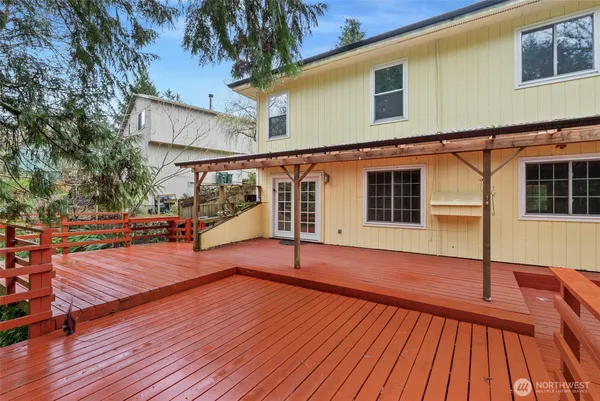 a view of a wooden deck with a yard