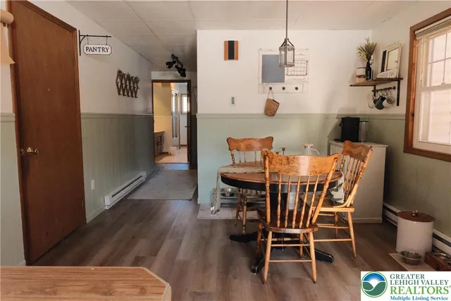 a dining room with furniture and wooden floor