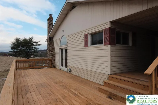 a front view of house with yard and car parked