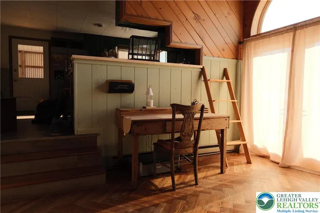 a view of a dining room with furniture and wooden floor