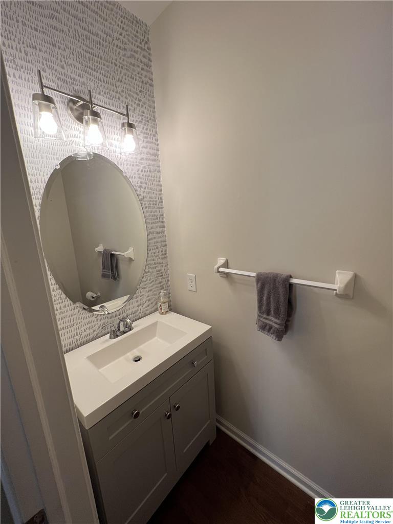 5380 Jutland Road Allentown, PA 18104 - Photo 24 of 27 A compact vanity with an oval mirror offers utility in this well-appointed powder room.