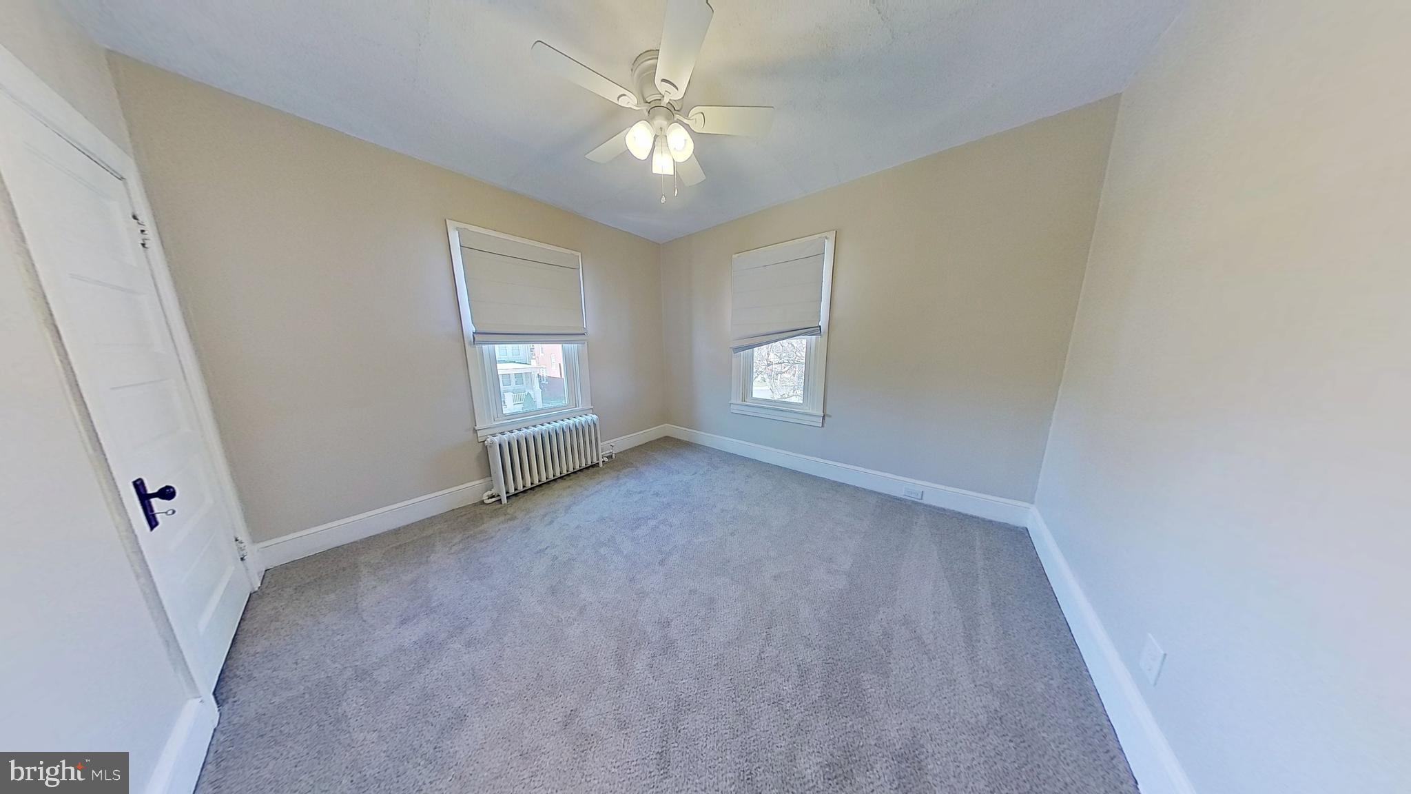549 Lancaster Avenue York, PA 17403 - Photo 5 of 11 an empty room with windows and ceiling fan