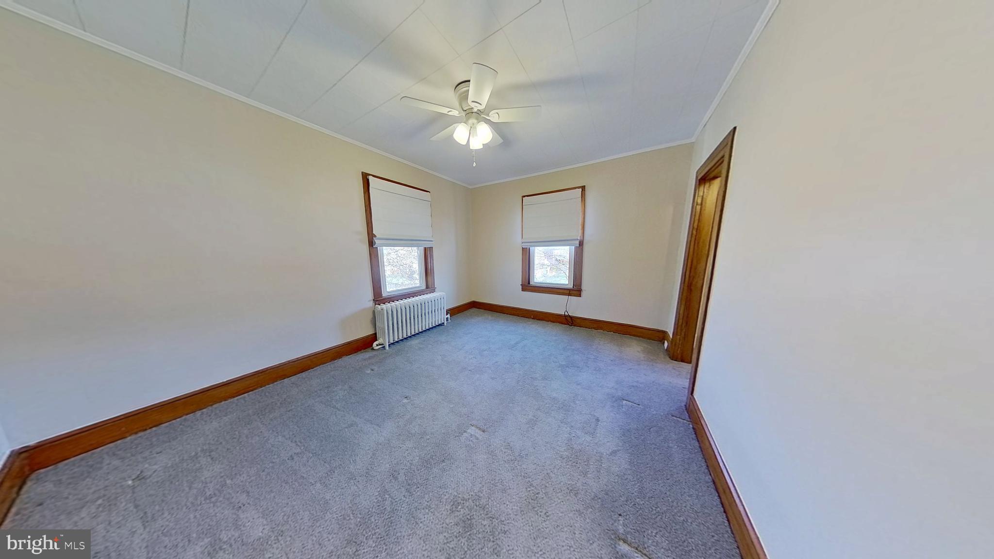 549 Lancaster Avenue York, PA 17403 - Photo 6 of 11 an empty room with windows and chandelier fan