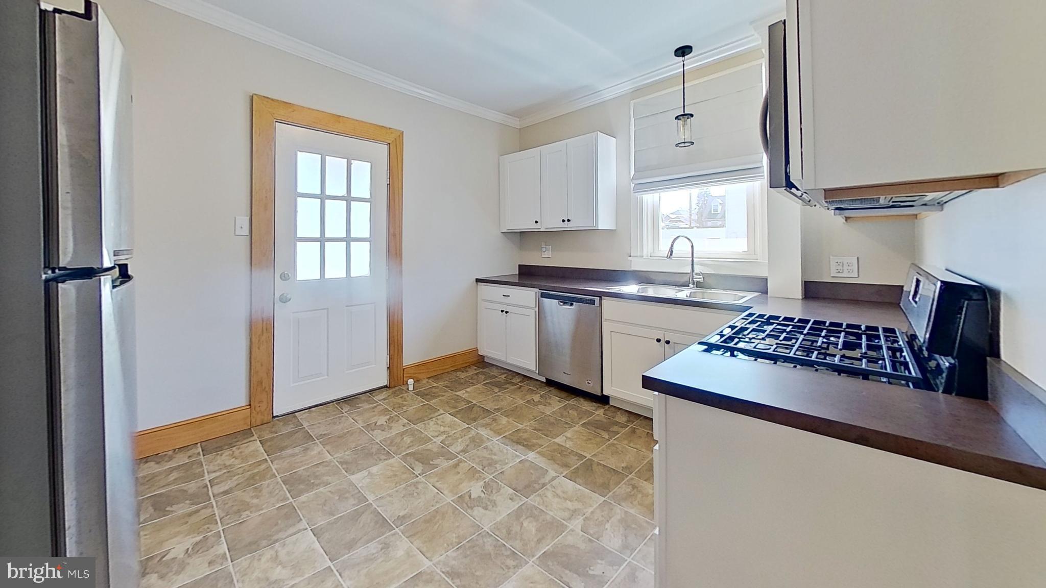 549 Lancaster Avenue York, PA 17403 - Photo 10 of 11 a kitchen with stainless steel appliances granite countertop a sink stove and cabinets