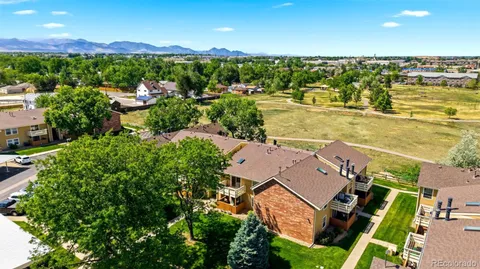 an aerial view of residential houses with outdoor space and river